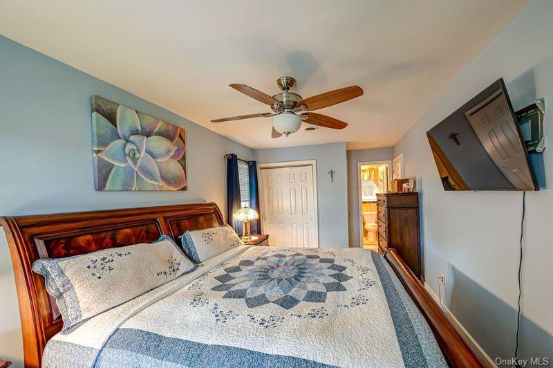 20 Bayview Road Amityville, NY 11701 - Photo 12 of 24 a bedroom with a bed and a flat screen tv