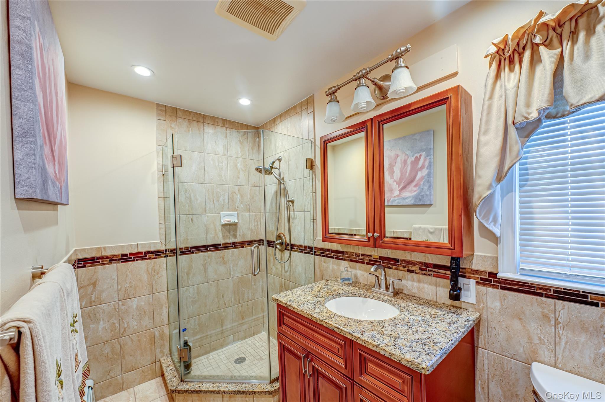 20 Bayview Road Amityville, NY 11701 - Photo 15 of 24 a bathroom with a granite countertop sink and a mirror