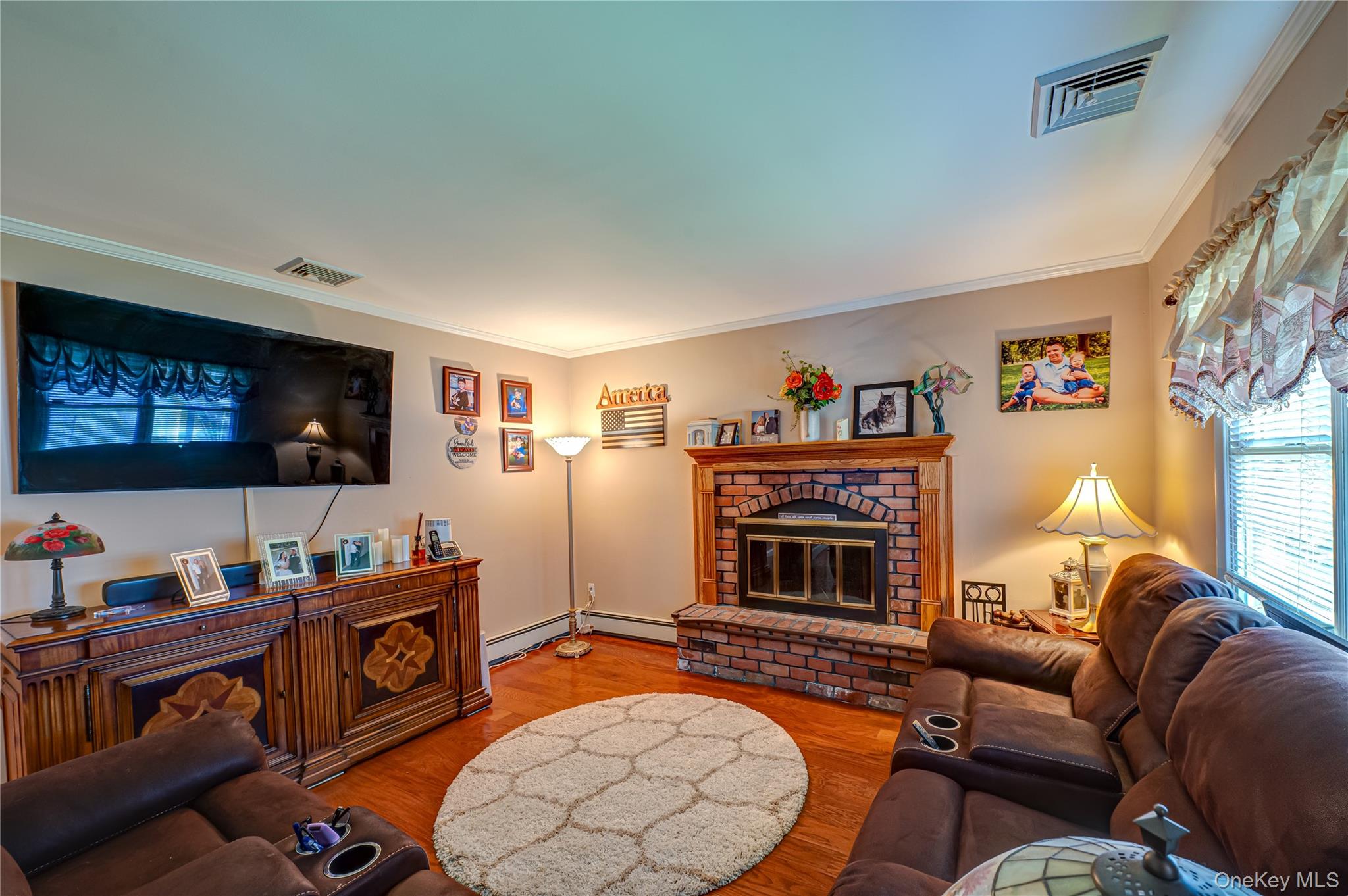 20 Bayview Road Amityville, NY 11701 - Photo 9 of 24 a living room with furniture a flat screen tv and a fireplace