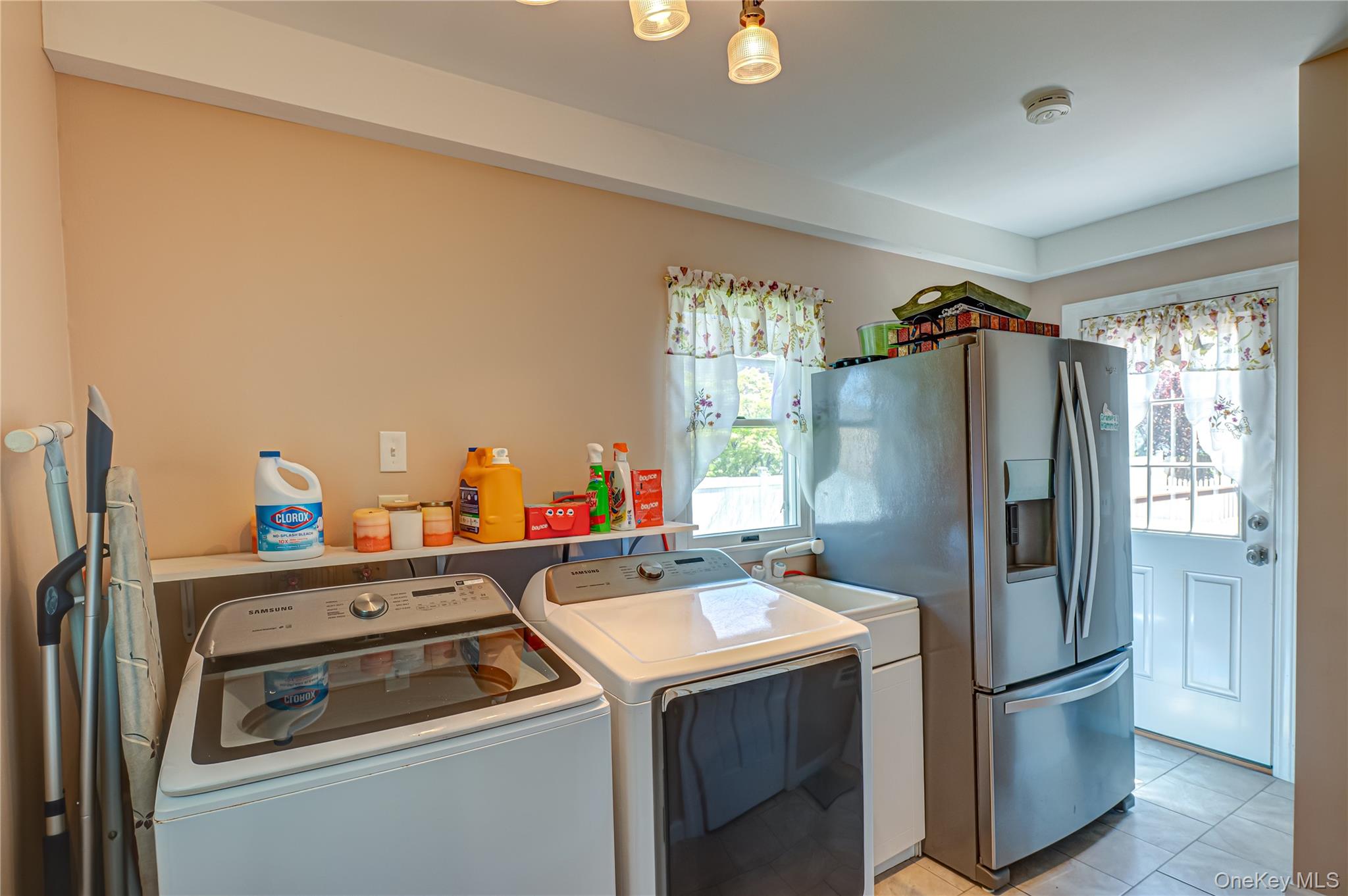 20 Bayview Road Amityville, NY 11701 - Photo 10 of 24 a kitchen with a refrigerator a stove a washer and dryer