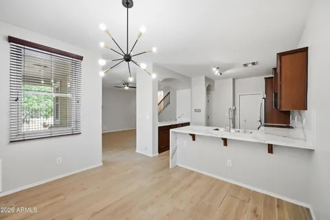 a view of kitchen with stainless steel appliances a sink and a large window