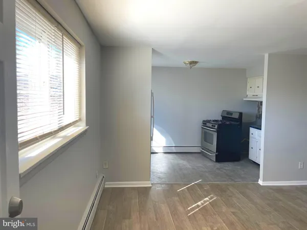 a view of a kitchen with refrigerator and window