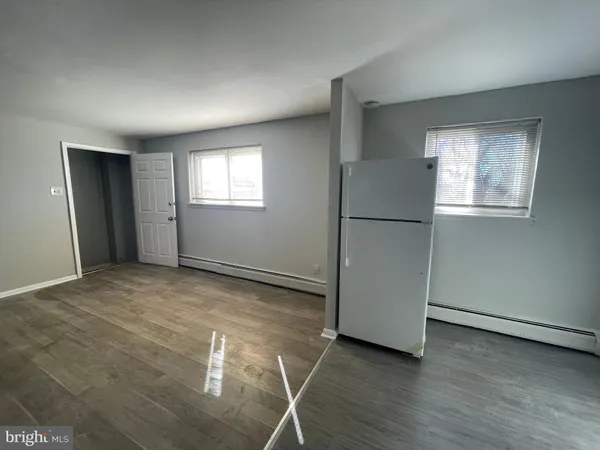 a view of an empty room and wooden floor