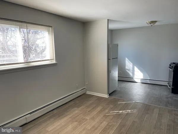 a view of a livingroom with an empty space and a window
