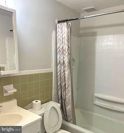 a bathroom with a toilet a sink and a shower