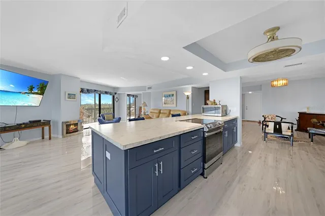 a spacious kitchen with stainless steel appliances granite countertop a lot of counter space and wooden floor