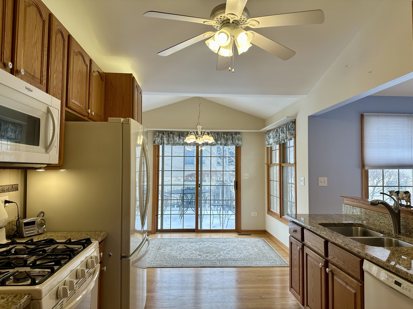 11904 Somerset Road Orland Park, IL 60467 - Photo 14 of 38 a kitchen with stainless steel appliances granite countertop a stove a sink and a microwave