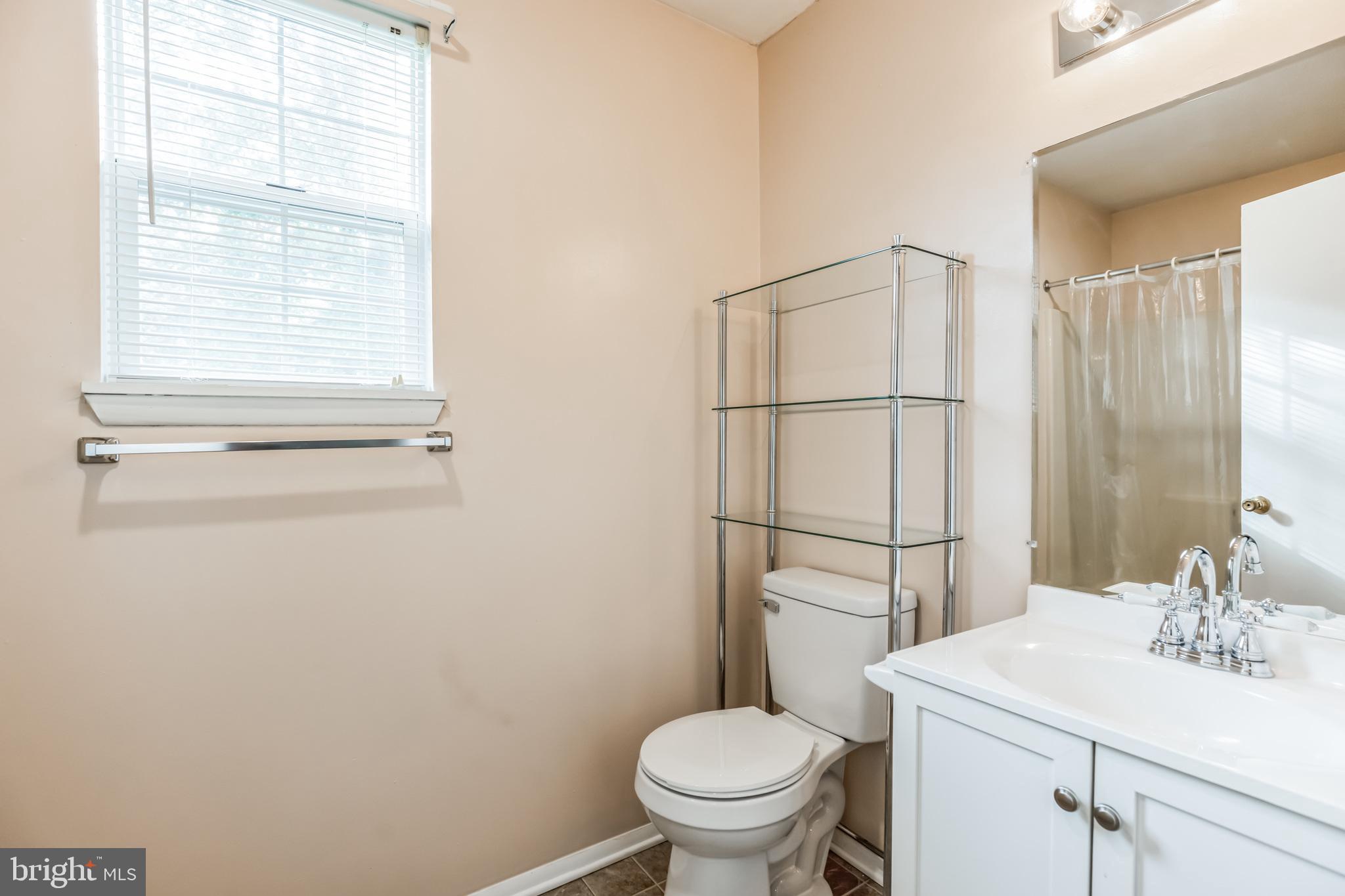 526 Maple Way Lusby, MD 20657 - Photo 17 of 26 a white toilet sitting next to a bathroom sink