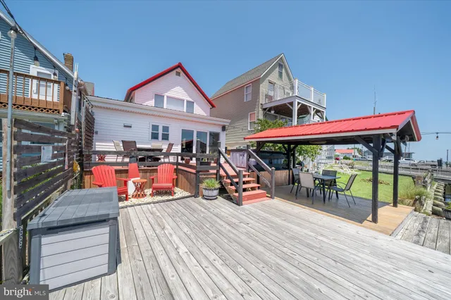 a view of a roof deck with table and chairs
