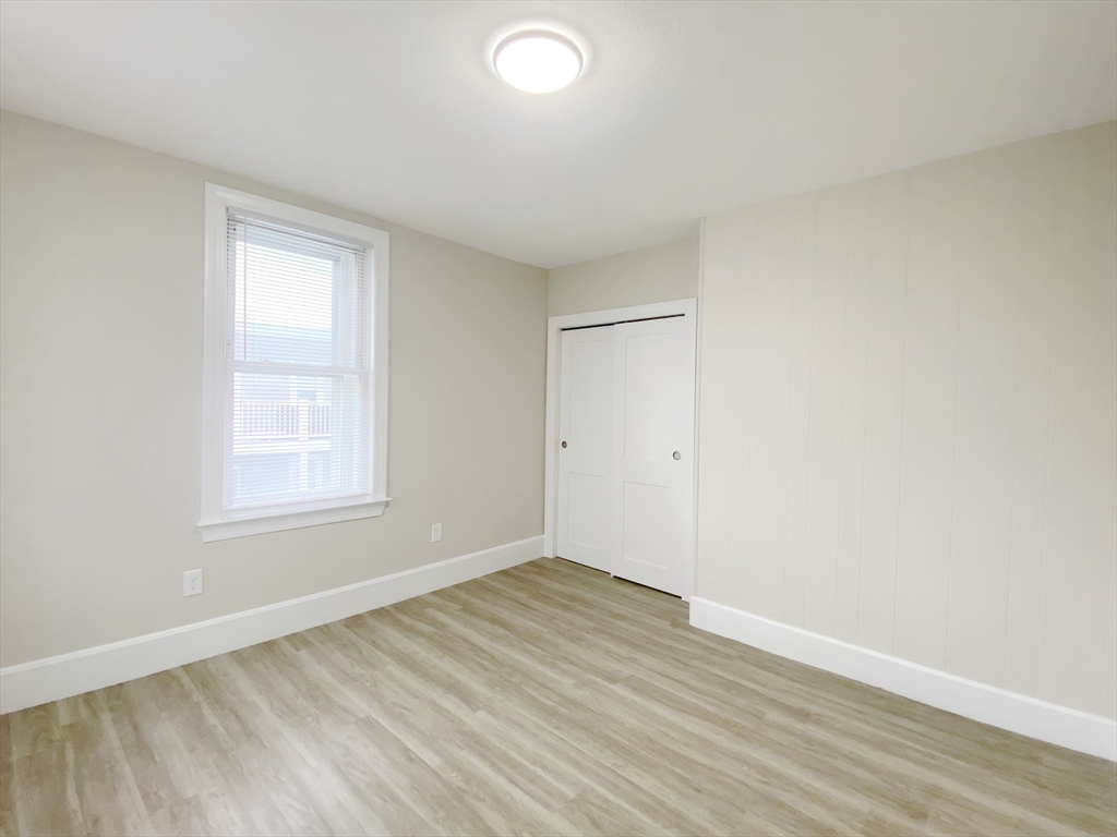 44 Jones Road, Unit 5 Revere, MA 02151 - Photo 11 of 11 an empty room with wooden floor and windows
