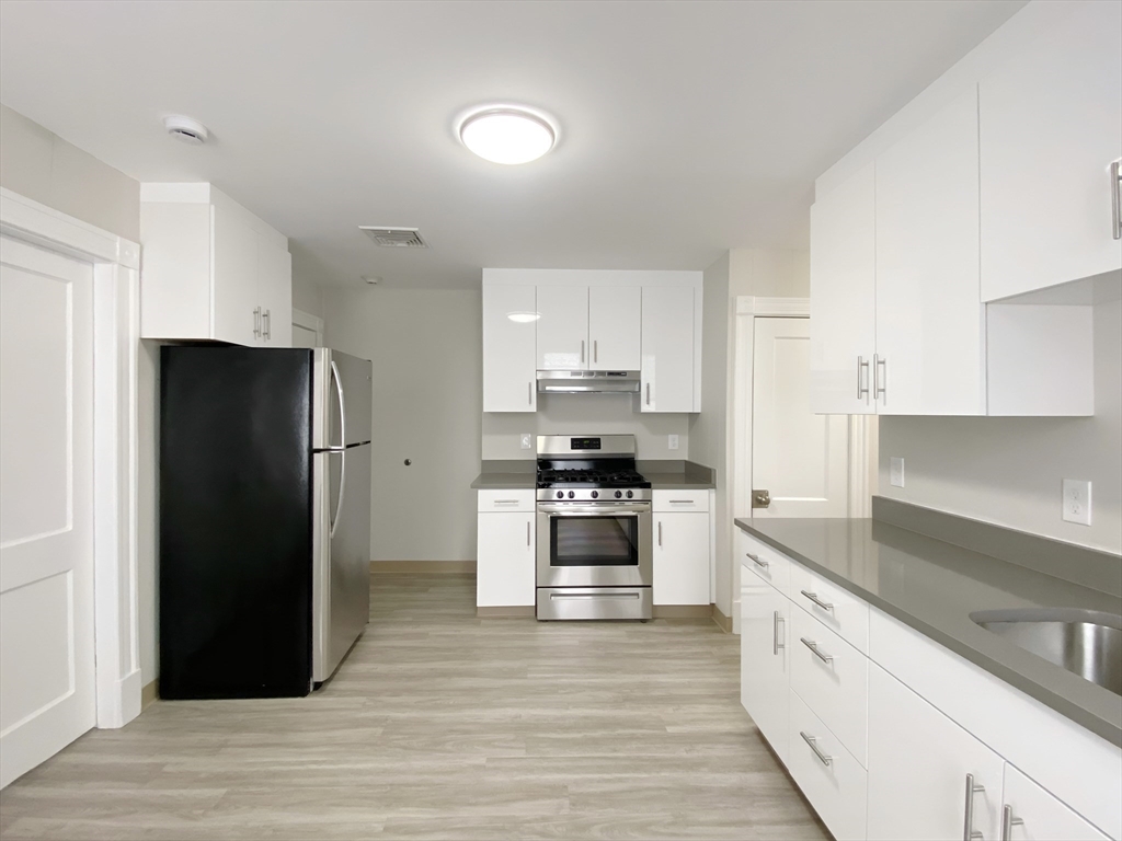 44 Jones Road, Unit 5 Revere, MA 02151 - Photo 2 of 11 a kitchen with a refrigerator and a stove top oven