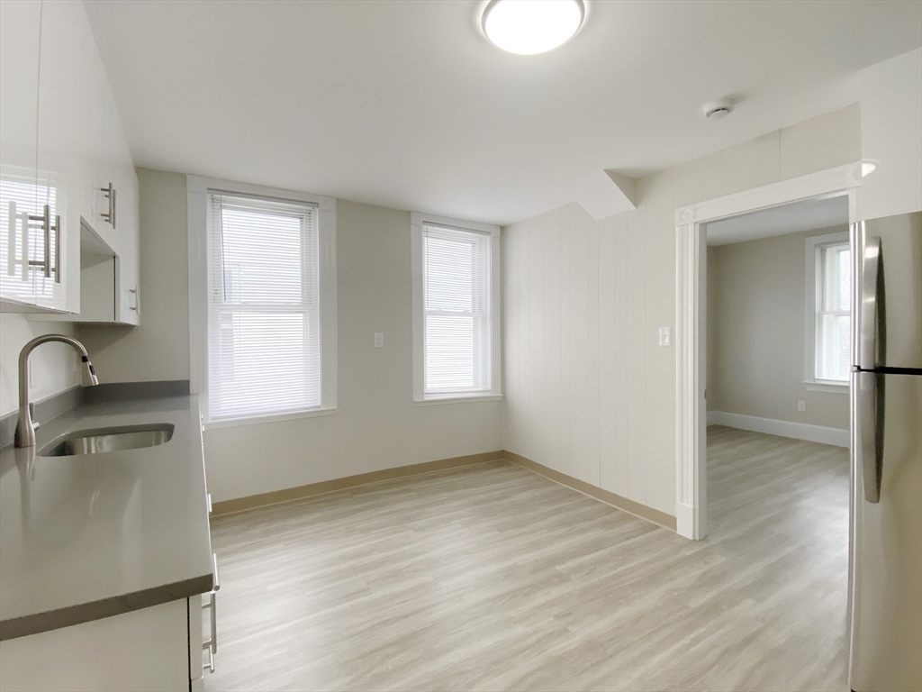 44 Jones Road, Unit 5 Revere, MA 02151 - Photo 7 of 11 a view of a kitchen with a sink dishwasher and wooden floor