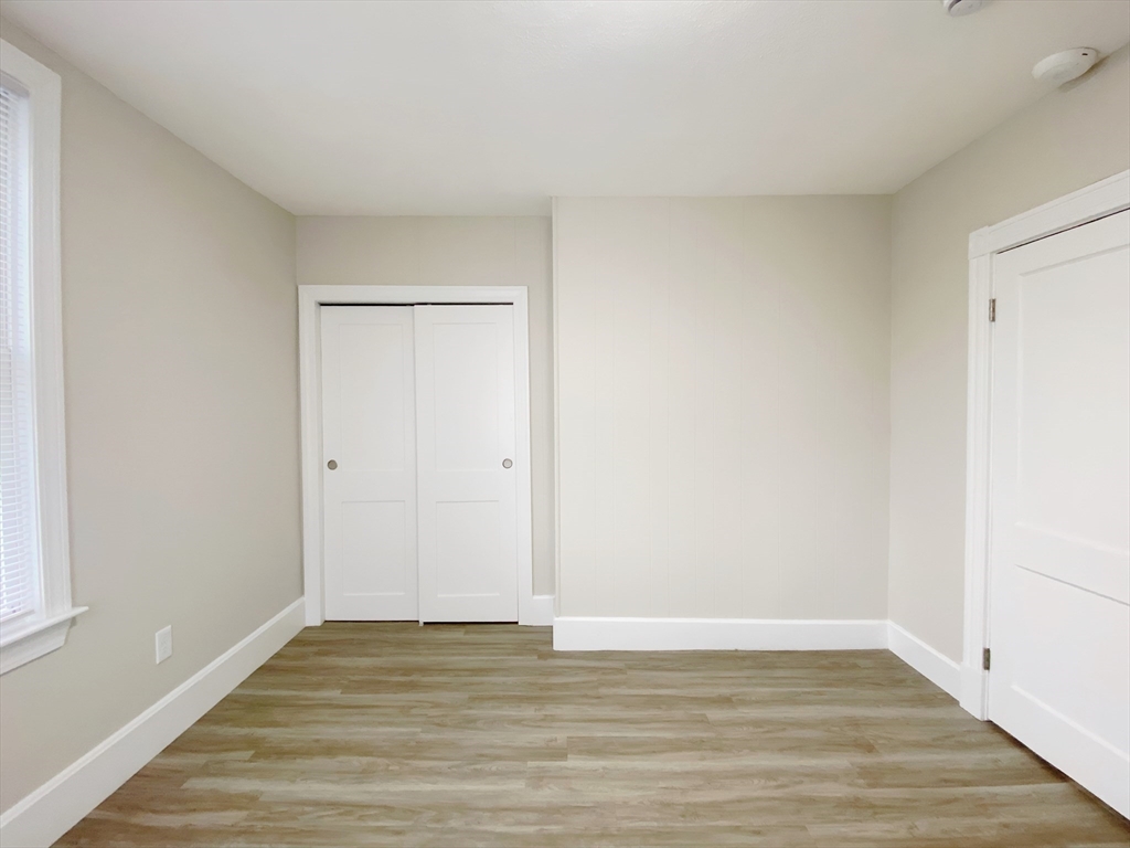 44 Jones Road, Unit 5 Revere, MA 02151 - Photo 10 of 11 a view of an empty room with wooden floor and a window
