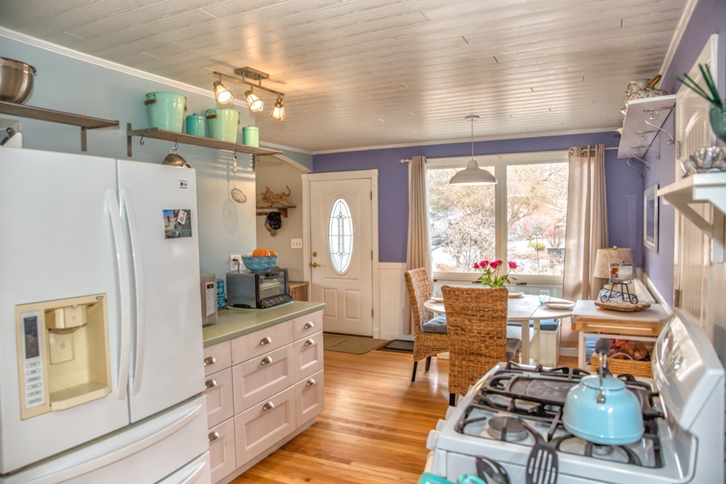 74 Ellendale Circle Springfield, MA 01128 - Photo 2 of 24 a kitchen with stainless steel appliances granite countertop a refrigerator a stove and a dining table with wooden floor