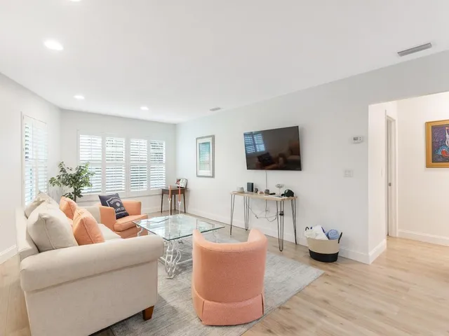 a living room with furniture and a potted plant