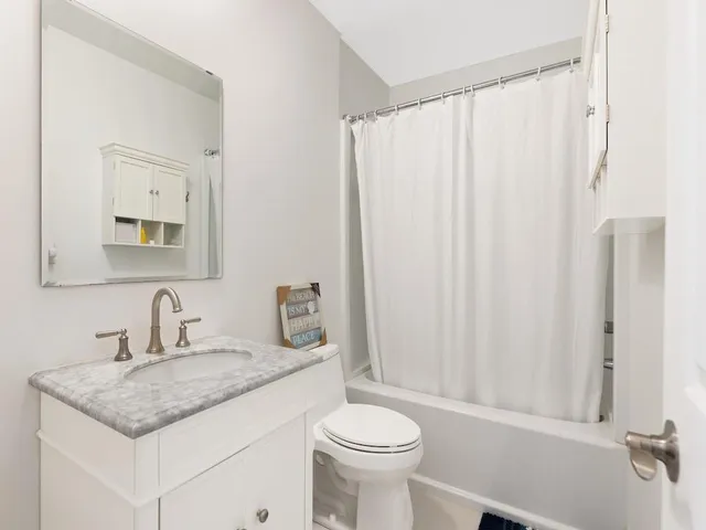 a kitchen with a sink cabinets and window