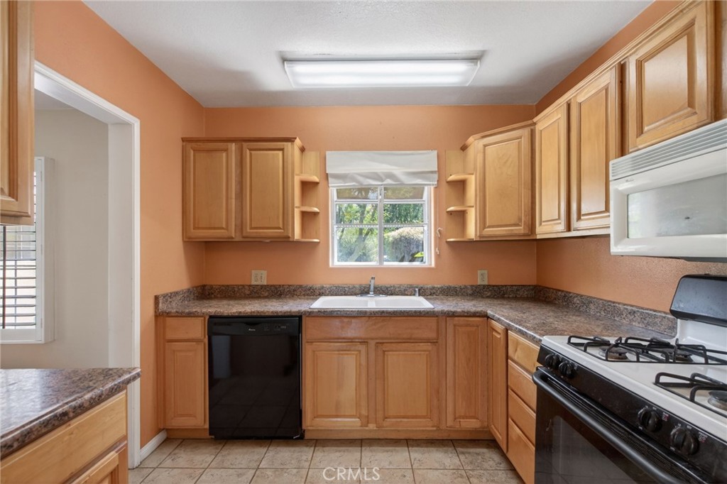 3560 McKinley Street Riverside, CA 92506 - Photo 11 of 45 a kitchen with stainless steel appliances granite countertop a stove a sink and a microwave