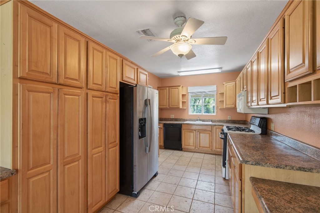 3560 McKinley Street Riverside, CA 92506 - Photo 12 of 45 a kitchen with refrigerator cabinets and window