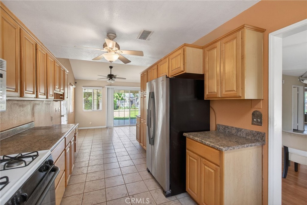 3560 McKinley Street Riverside, CA 92506 - Photo 13 of 45 a kitchen with stainless steel appliances granite countertop a refrigerator a stove and a sink