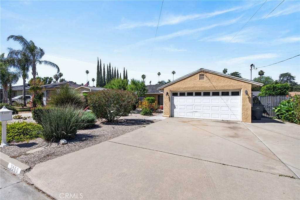 3560 McKinley Street Riverside, CA 92506 - Photo 3 of 45 a front view of a house with a yard and garage
