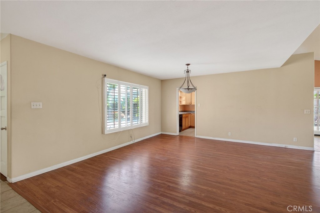 3560 McKinley Street Riverside, CA 92506 - Photo 5 of 45 an empty room with wooden floor and windows
