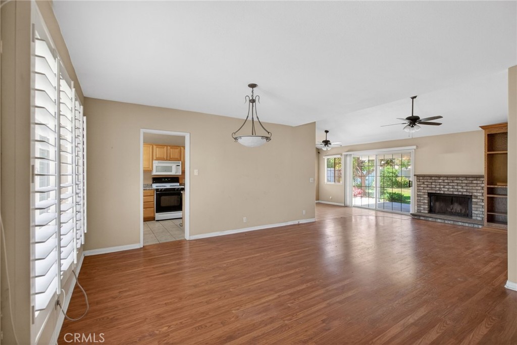 3560 McKinley Street Riverside, CA 92506 - Photo 6 of 45 a view of empty room with wooden floor fireplace and windows