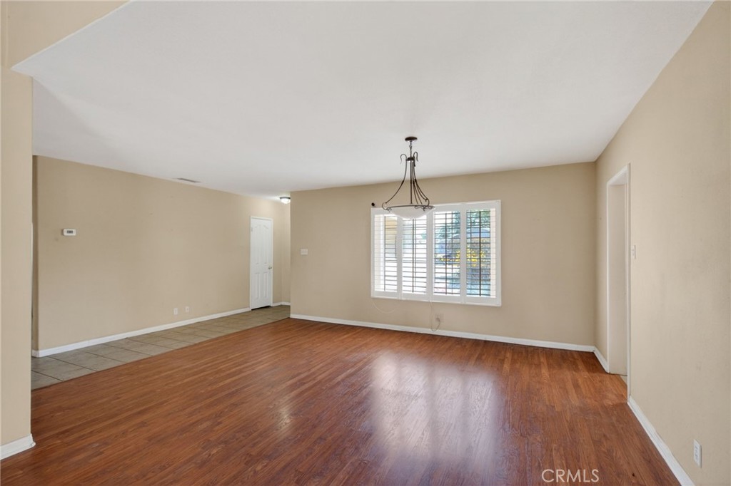 3560 McKinley Street Riverside, CA 92506 - Photo 7 of 45 an empty room with wooden floor and windows