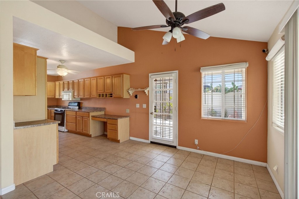 3560 McKinley Street Riverside, CA 92506 - Photo 9 of 45 a kitchen with stainless steel appliances granite countertop a refrigerator a oven a sink and dishwasher with a dining table