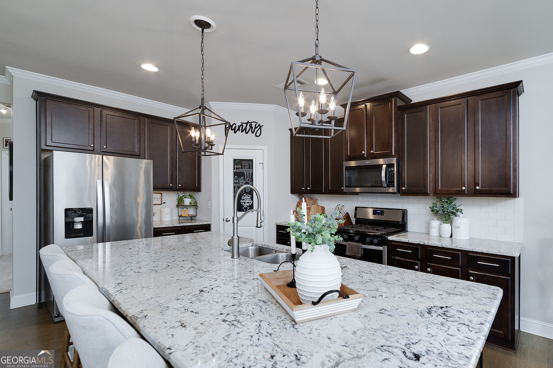 4366 Clubside Drive Gainesville, GA 30504 - Photo 7 of 24 a kitchen with stainless steel appliances kitchen island granite countertop a refrigerator a stove a sink dishwasher a dining table and chairs with wooden floor