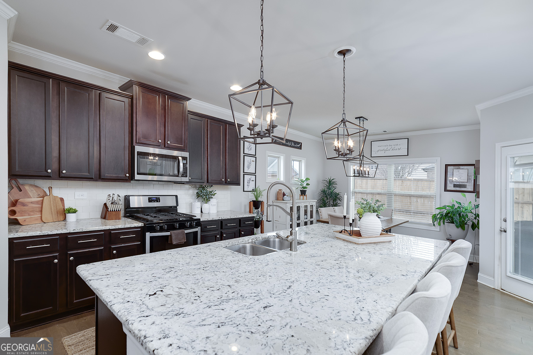 4366 Clubside Drive Gainesville, GA 30504 - Photo 8 of 24 a kitchen with stainless steel appliances granite countertop a sink stove and refrigerator