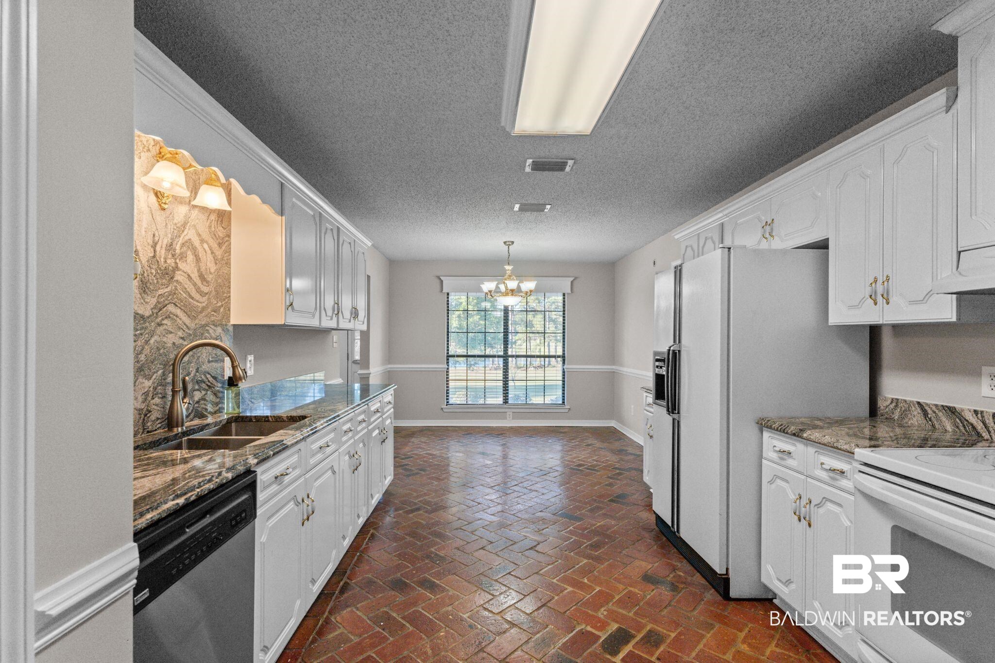 888 Mobile Cut-Off Road St. Stephens, AL 36569 - Photo 13 of 54 Kitchen with white appliances, dark stone countertops, a chandelier, white cabinetry, and a textured ceiling