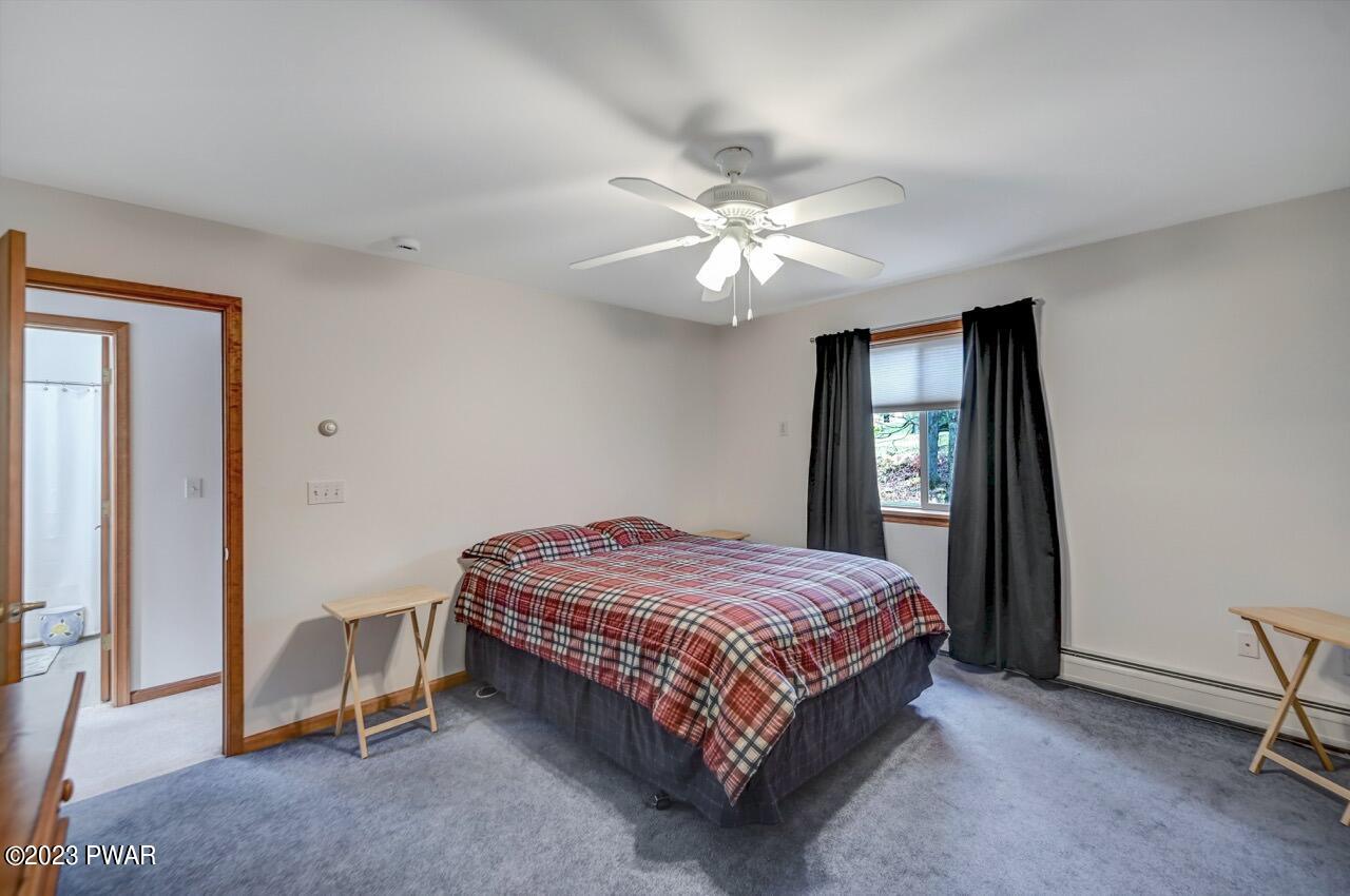 1294 Brookfield Road Lake Ariel, PA 18436 - Photo 43 of 75 a bedroom with a bed and a chandelier