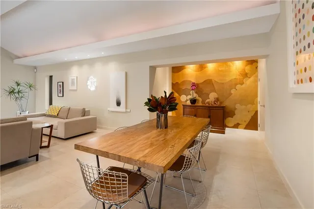 a living room with furniture a rug and a large window