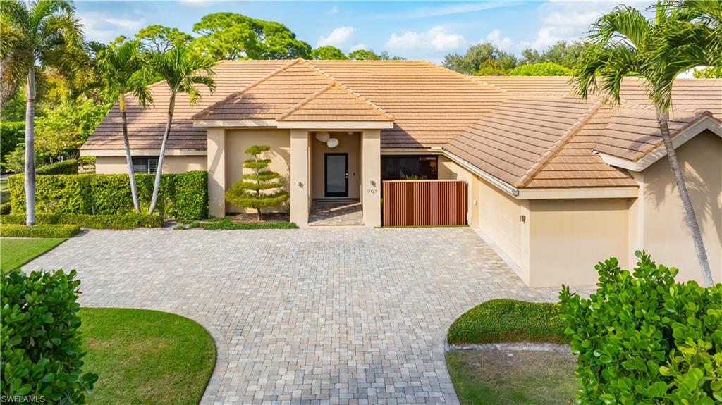 705 Shadow Lake Lane Naples, FL 34108 - Photo 18 of 47 front view of a house with a yard