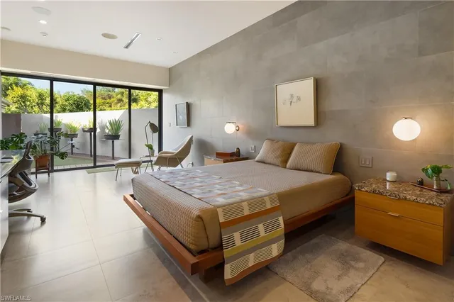 a bedroom with a bed and glass door