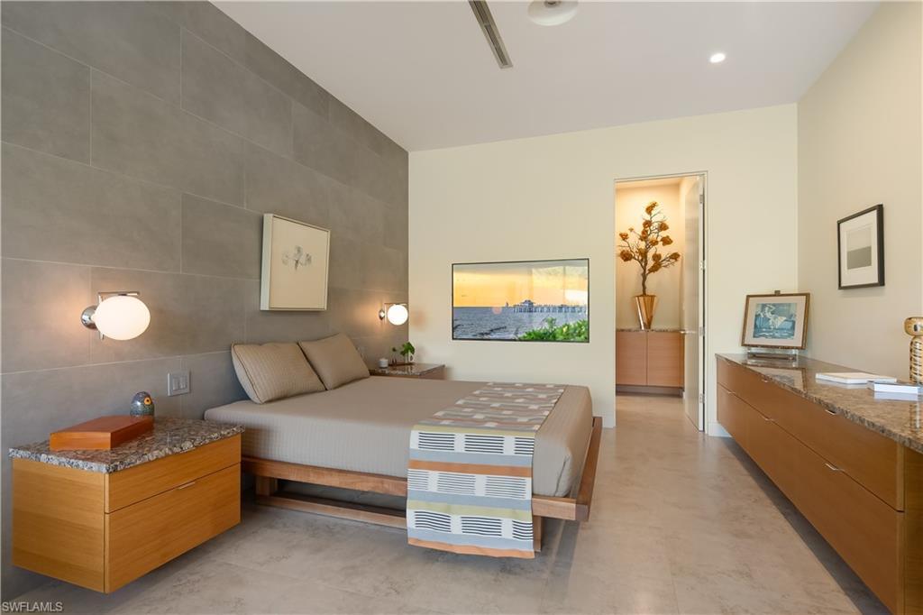 705 Shadow Lake Lane Naples, FL 34108 - Photo 20 of 47 a bedroom with a bed and a flat screen tv