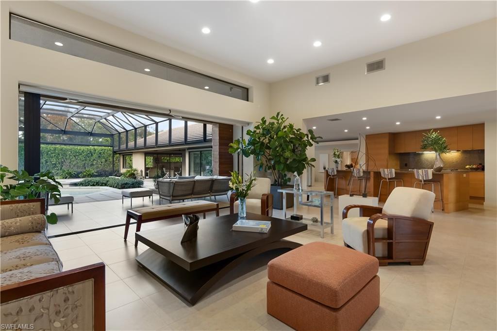 705 Shadow Lake Lane Naples, FL 34108 - Photo 2 of 47 a living room with furniture and a large window