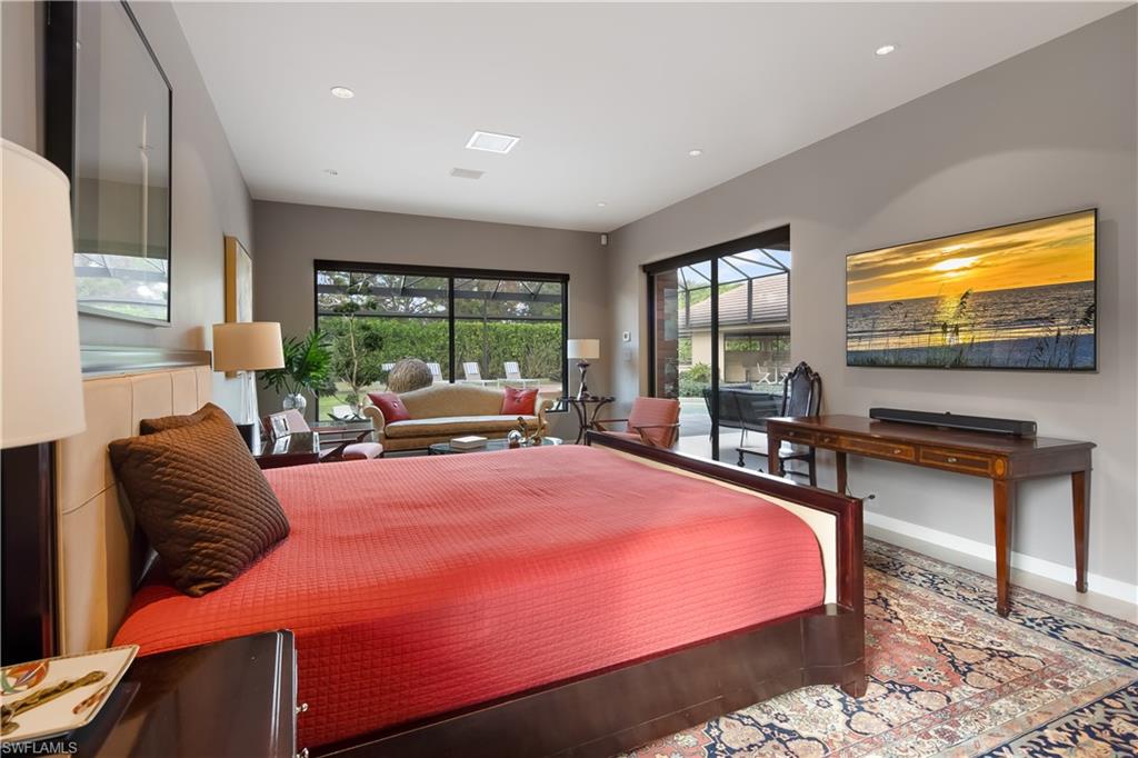705 Shadow Lake Lane Naples, FL 34108 - Photo 23 of 47 a bedroom with a bed and glass windows