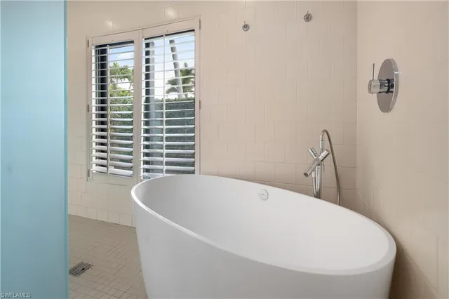 a white bath tub sitting in a bathroom