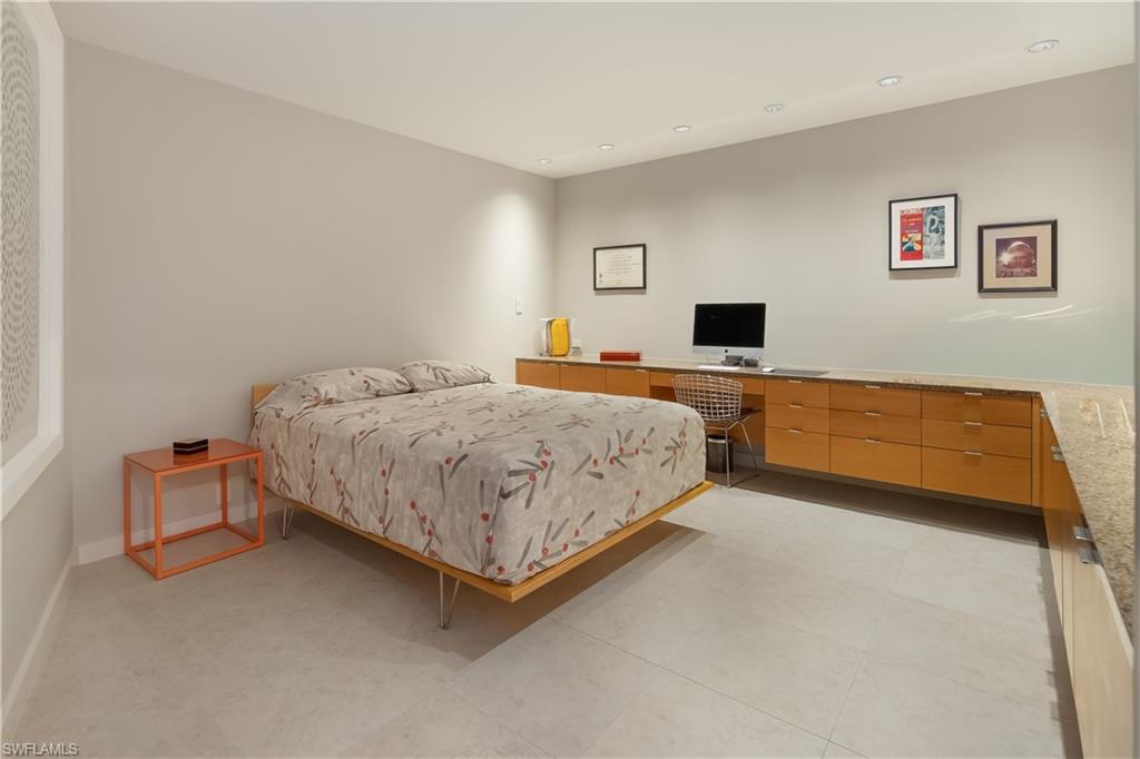 705 Shadow Lake Lane Naples, FL 34108 - Photo 28 of 47 a bedroom with a bed and a flat screen tv