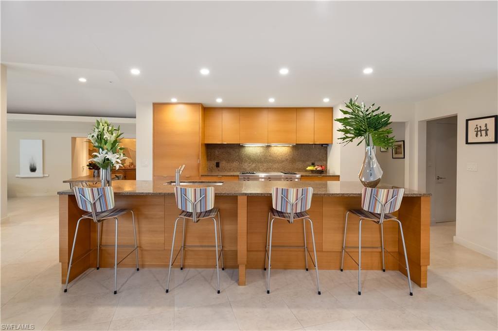 705 Shadow Lake Lane Naples, FL 34108 - Photo 3 of 47 a room with lots of chairs and mirrors