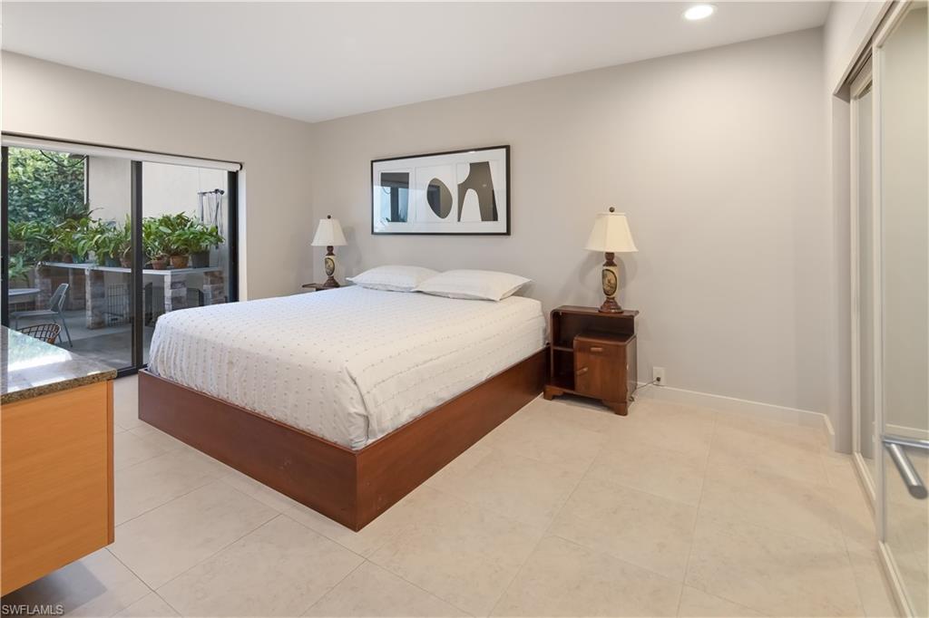 705 Shadow Lake Lane Naples, FL 34108 - Photo 34 of 47 a large bed sitting in a bedroom next to a window