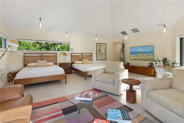 a living room with furniture and a large mirror