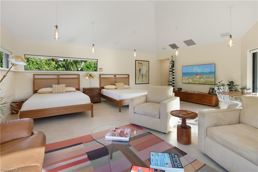 705 Shadow Lake Lane Naples, FL 34108 - Photo 37 of 47 a living room with furniture and a large mirror