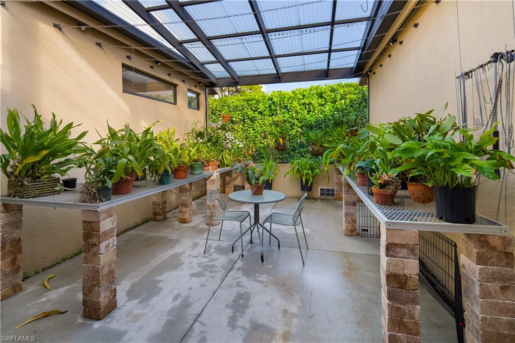 705 Shadow Lake Lane Naples, FL 34108 - Photo 42 of 47 a potted plant sitting in front of a building