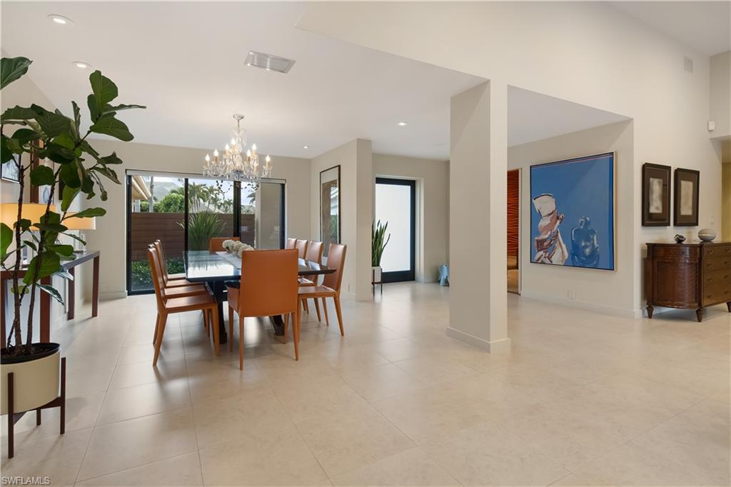 705 Shadow Lake Lane Naples, FL 34108 - Photo 7 of 47 a dining room with furniture potted plants and wooden floor