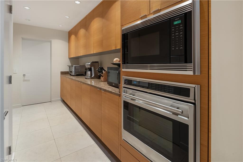 705 Shadow Lake Lane Naples, FL 34108 - Photo 10 of 47 a kitchen with a stove and a microwave