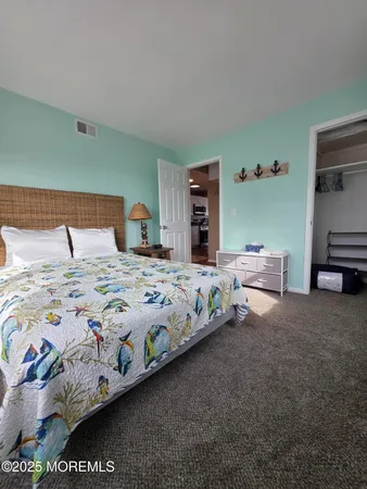 a bedroom with bed and a night stand