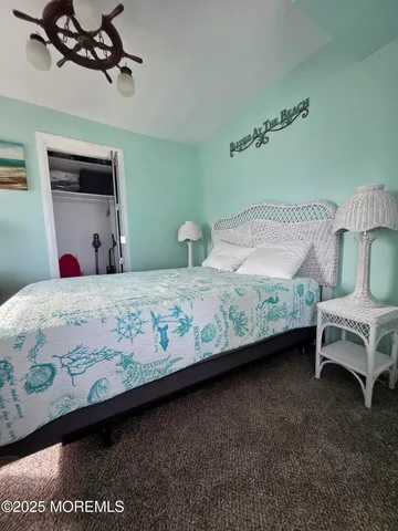 a bedroom with a bed a couch and dresser