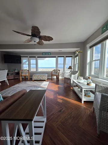 a living room with a couch dining table and a large window